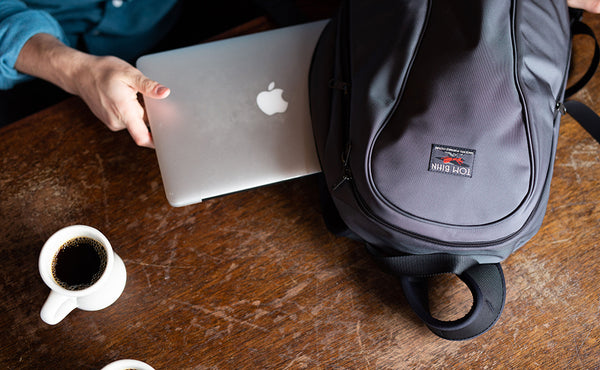 A close shot of a laptop being removed from the Luminary 15 at a cafe.
